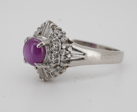 A modern platinum, star ruby and diamond cluster set dress ring, size J/K, gross weight 4.7 grams. Condition - fair to good